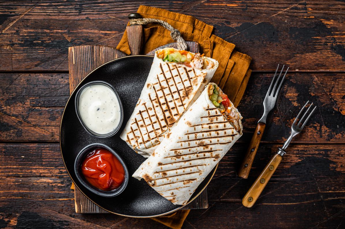 Shawarma, Shaurma chicken roll  with  vegetable salad. Wooden background. Top view