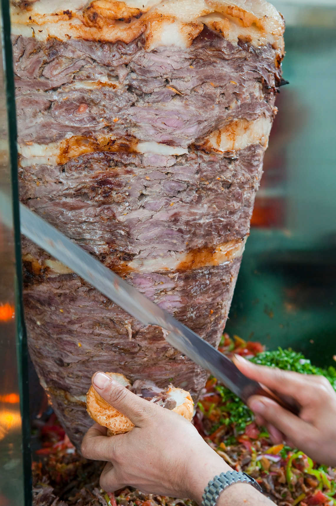 Shawarma meat being cut for sandwich